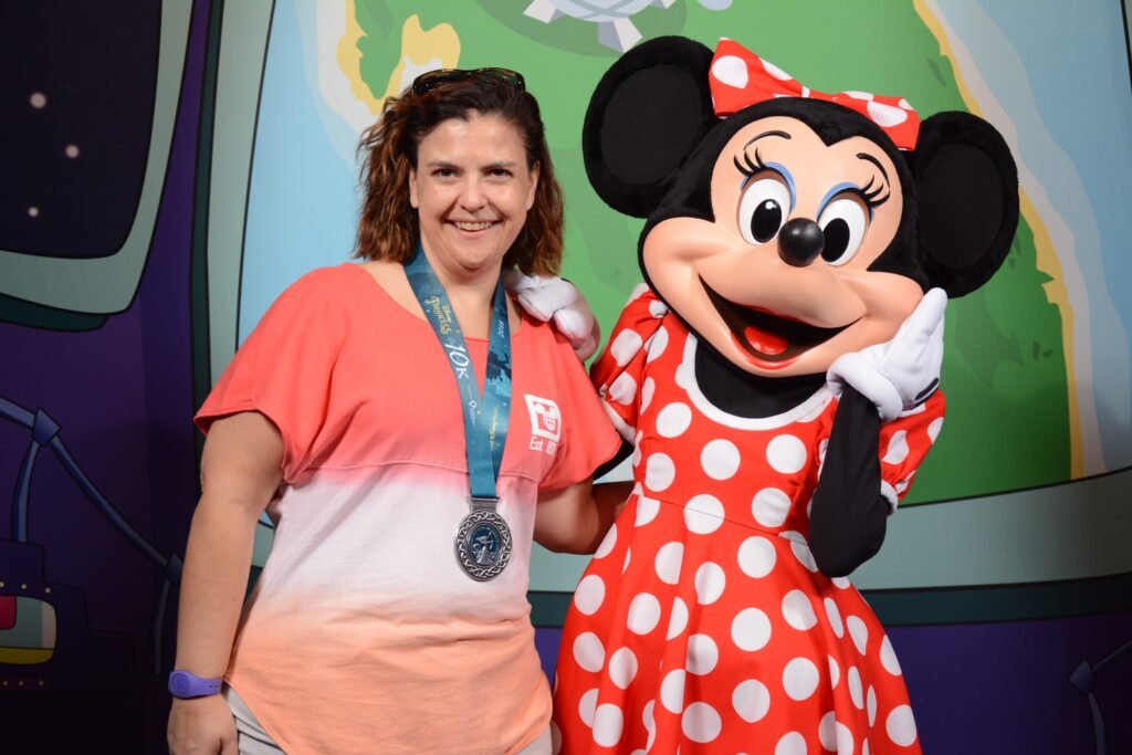 Laura Mooney, Travel Planner with Kingdom Planners, posing with Minnie Mouse